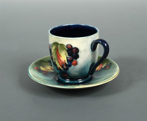 Lot 44 - A Moorcroft Leaves and Berries coffee can and saucer