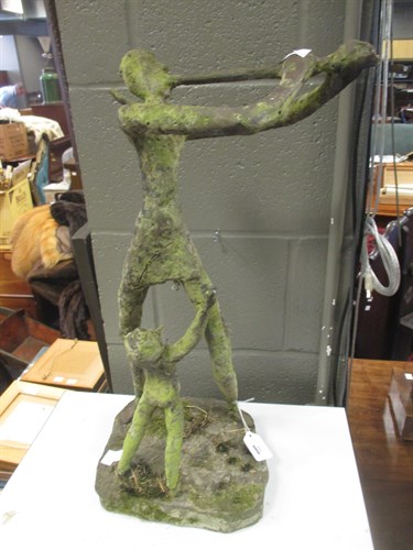 Lot 332 - A cast iron sculpture of a man playing a...