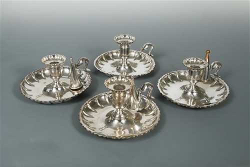 Lot 497 - A set of four silver plated chambersticks
