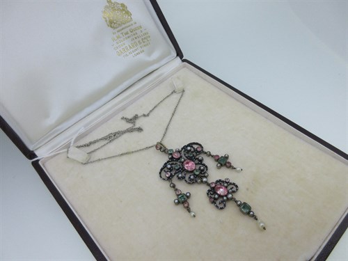 Lot 246 - A late 19th century enamel and gemstone pendant on chain