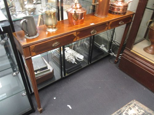 Lot 483 - A mahogany sidetable with three drawers on...