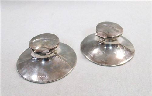 Lot 640 - A pair of Edward VII silver capstan inkwells