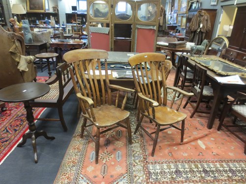 Lot 393 - A near pair of ash and elm comb back armchairs...
