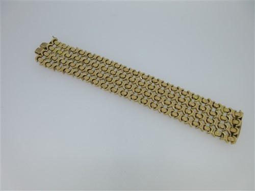 Lot 156 - A mesh link cuff bracelet stamped '750'