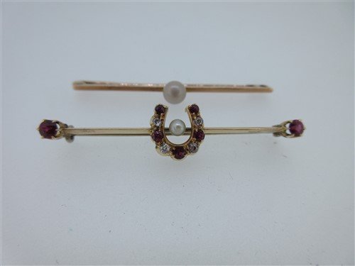 Lot 169 - A ruby, diamond and seed pearl horseshoe bar brooch together with a pearl bar brooch