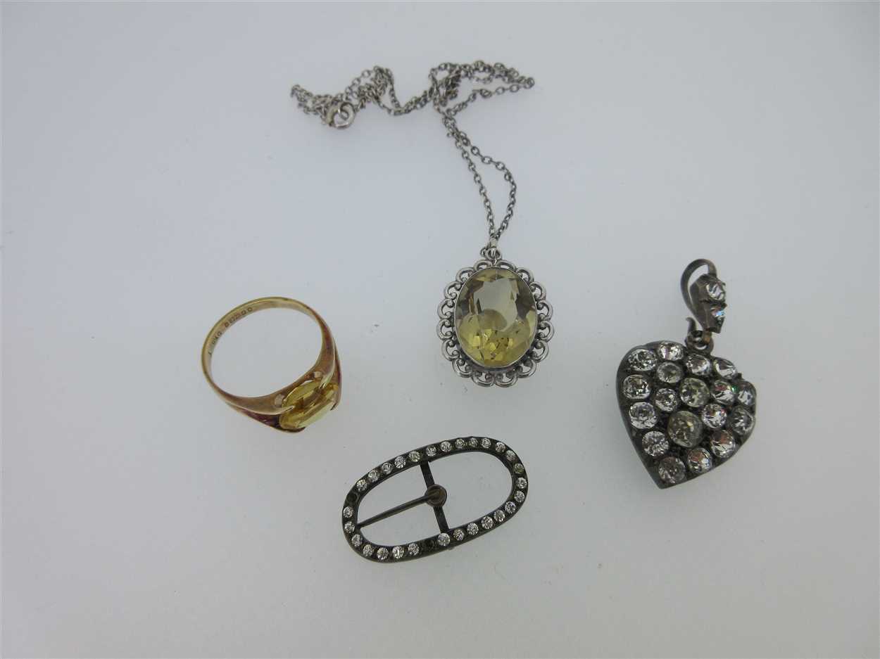 Lot 78 - A vintage paste set heart pendant, a citrine pendant and two other citrine or paste pieces