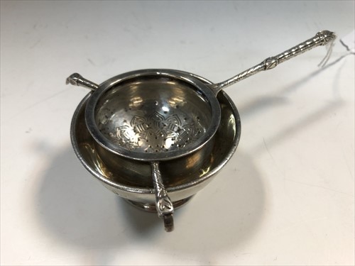 Lot 94 - A George V silver tea strainer by Liberty & Co.
