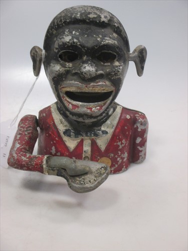 Lot 45 - An antique automaton money box in the form of...