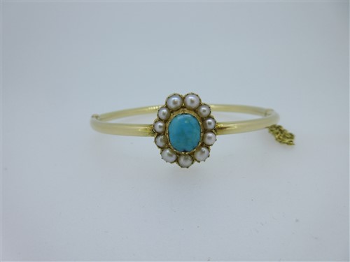 Lot 183 - A turquoise and seed pearl set hinged bangle