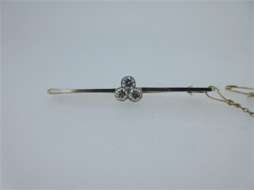 Lot 233 - A bar brooch set with a trefoil of diamonds