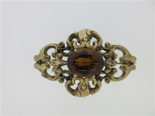 Lot 18 - A Victorian citrine brooch in an ornate mount