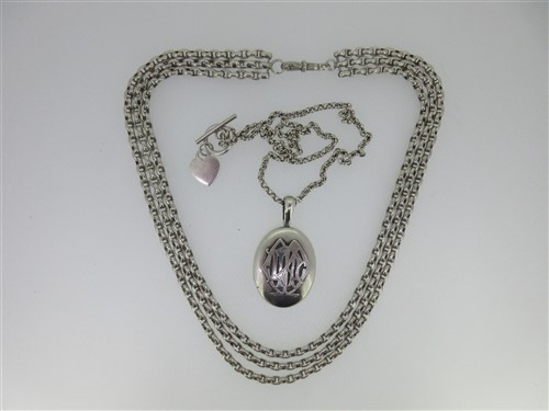 Lot 41 - A Victorian silver locket together with a three row chain necklace