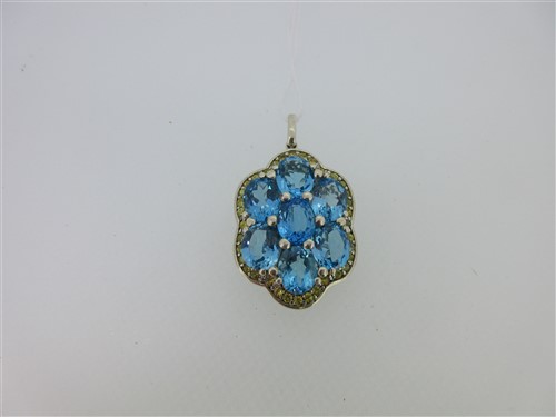 Lot 13 - A pendant set with a cluster of blue topaz and yellow sapphires