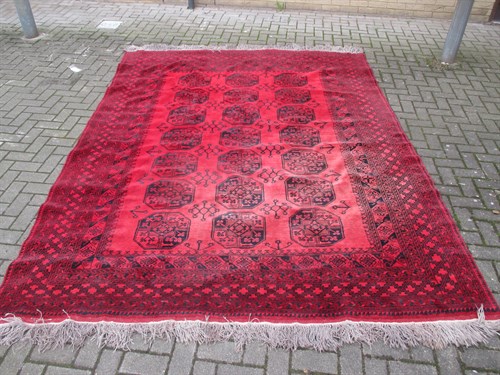 Lot 697 - A red ground Afghan type rug 330 x 238cm