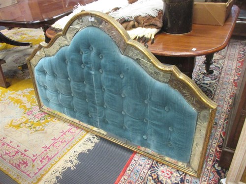 Lot 412 - A padded headboard with mirrored panel border...