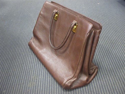 Lot 100A - A Gianni Versace brown leather handbag;...