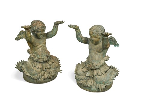 Lot 18 - A pair of Continental patinated bronze bust-length figures of half putti