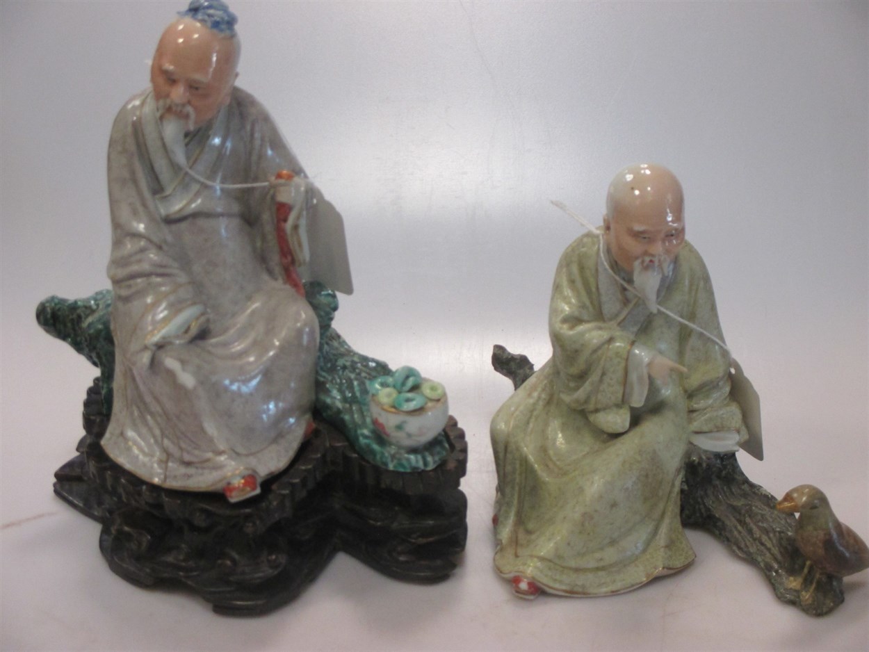 Lot 1 - Two Chinese porcelain figures of seated sages,...