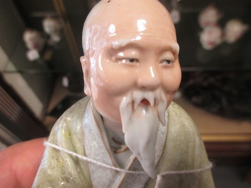 Lot 1 - Two Chinese porcelain figures of seated sages,...