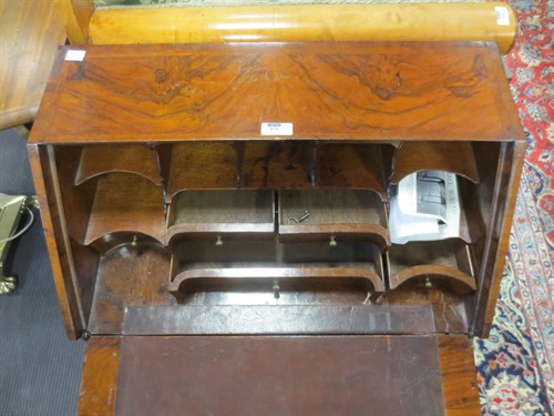 Lot 677 - A small walnut bureau in Queen Anne style....