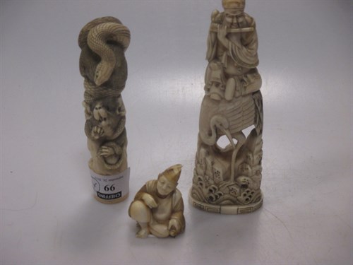 Lot 99A - An ivory Okimono of a flute player, seated on...