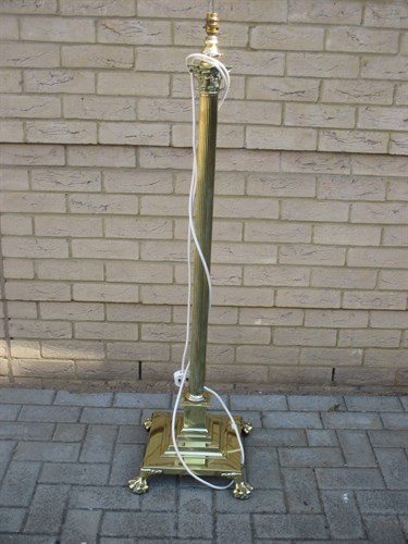 Lot 405 - A brass standing lamp in the form of a...