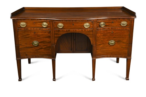 Lot 458 - A George III mahogany serpentine sideboard with galleried back