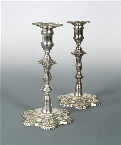 Lot 556 - A pair of George II cast silver candlesticks
