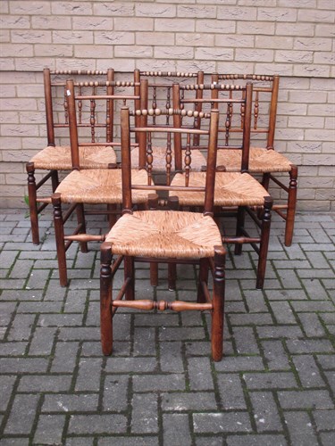 Lot 619 - A set of six spindle back ash chairs with rush...
