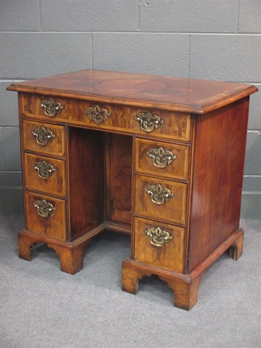 Lot 523 - An 18th century walnut kneehole desk on...