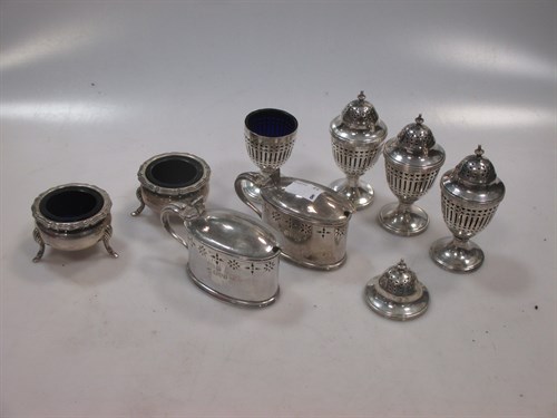Lot 408 - Four silver pierced pepper casters, together...