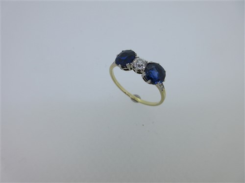 Lot 192 - An unusual sapphire and diamond three stone ring