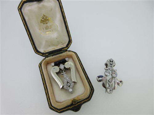 Lot 163 - A mid 20th century diamond and enamel clip by A.E. Köchert, and another similar all diamond clip