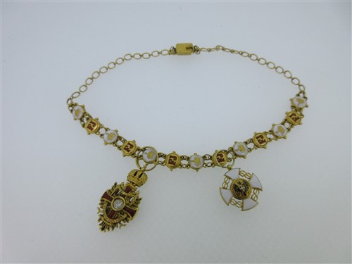 Lot 121 - A Hungarian 18ct gold and enamel bracelet with two chivalric order pendants