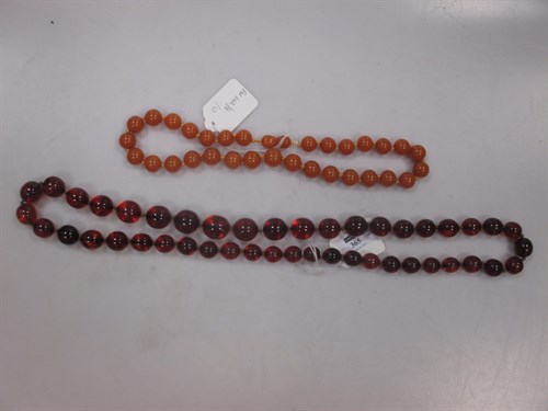 Lot 365 - A short row of butterscotch amber-coloured...