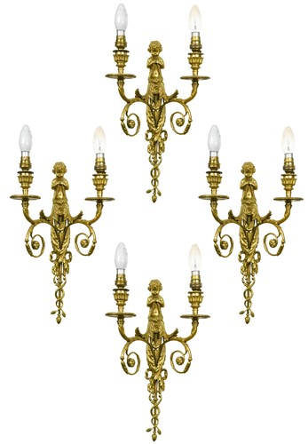 Lot 309 - A set of four twin-branch gilt metal wall lights