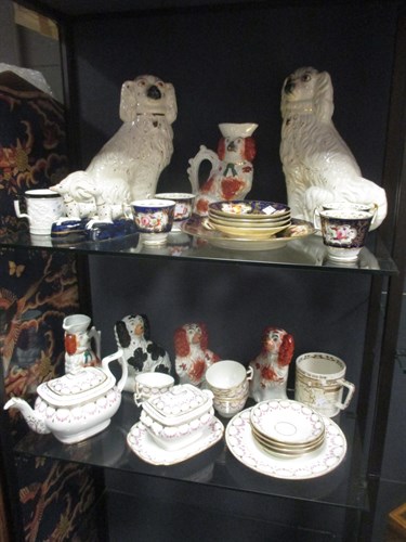 Lot 247 - A collection of Staffordshire pottery dogs,...