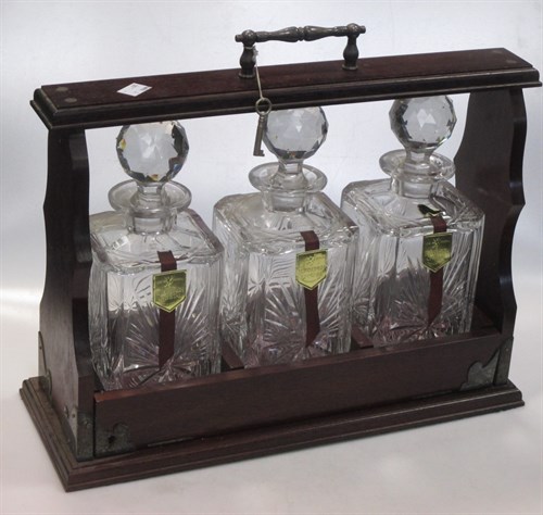 Lot 242 - A three bottle tantalus and old tin dairy...