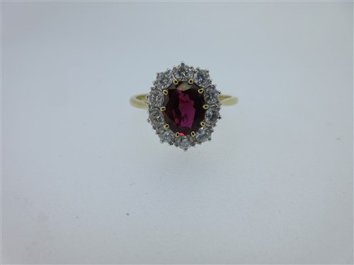 Lot 299 - A ruby and diamond cluster ring set in 18ct gold