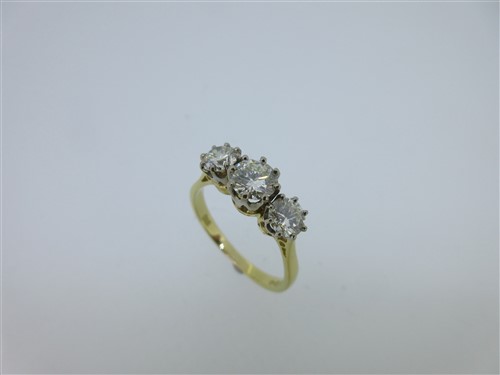 Lot 275 - An 18ct gold and three stone diamond ring