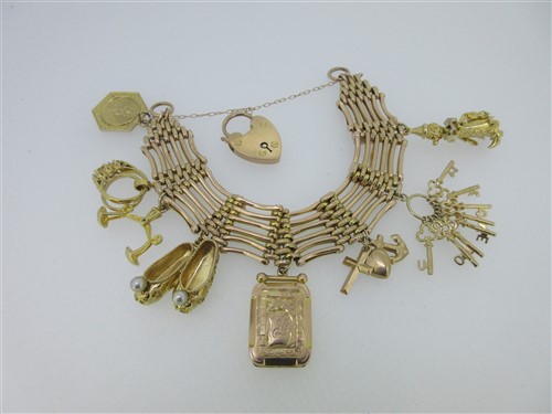 Lot 72 - A gatelink bracelet suspending eight charms