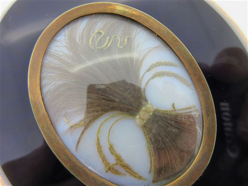 Lot 125 - A portrait miniature attributed to Adam Buck with hairwork and enamel back