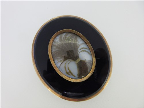 Lot 125 - A portrait miniature attributed to Adam Buck with hairwork and enamel back