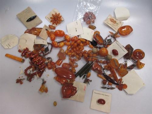 Lot 375 - A collection of amber coloured jewellery and...