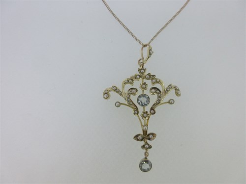 Lot 218 - An Edwardian aquamarine and seed pearl pendant with chain