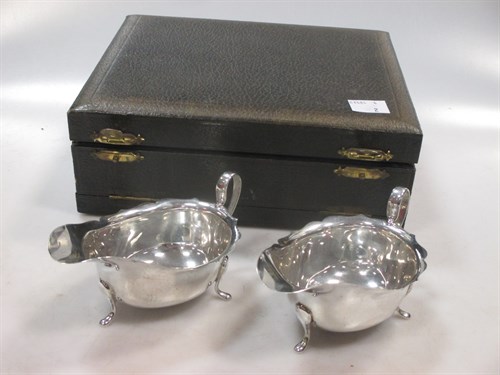 Lot 422 - A matching pair of silver sauce boats in a...