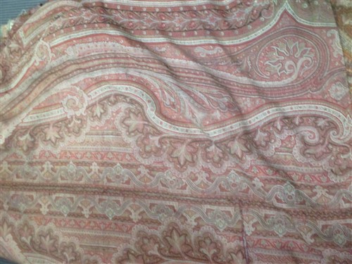 Lot 127 - A 19th Century Paisley shawl in maroons, reds...