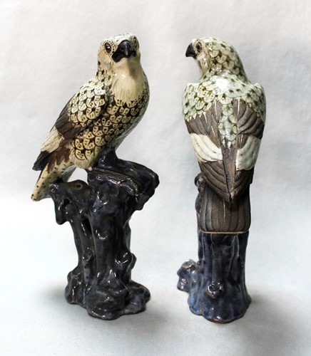 Lot 64 - A pair of Chinese Shiwan pottery models of hawks