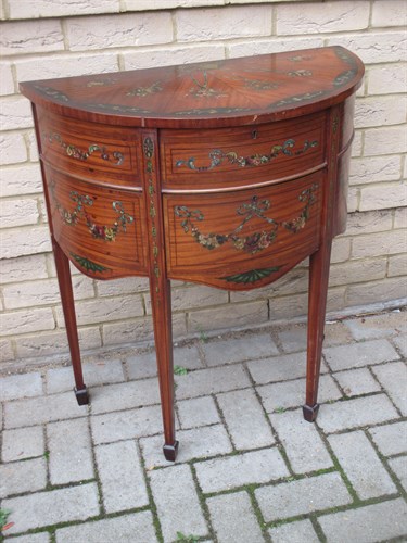 Lot 587 - An Edwardian painted satinwood demi-lune...
