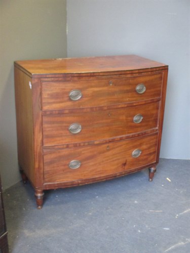 Lot 388 - A Regency mahogany bow front chest of drawers...